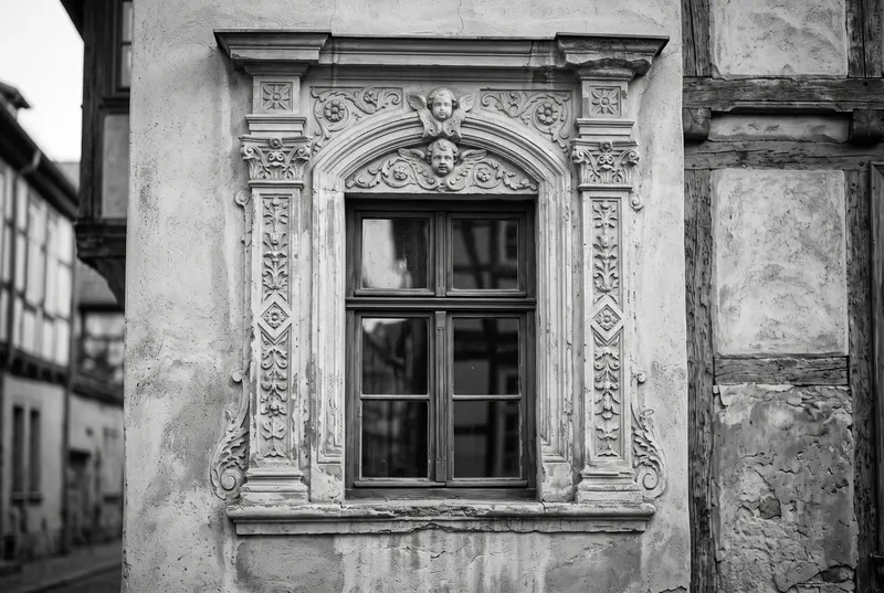 Historisches Fenster mit reich verziertem Stuckrahmen